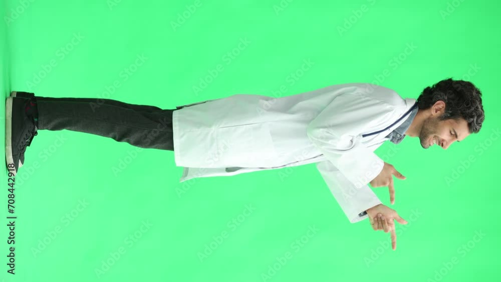 male doctor in a white coat on a green background smiling in full length male doctor in a white coat on a green background smiling in full length