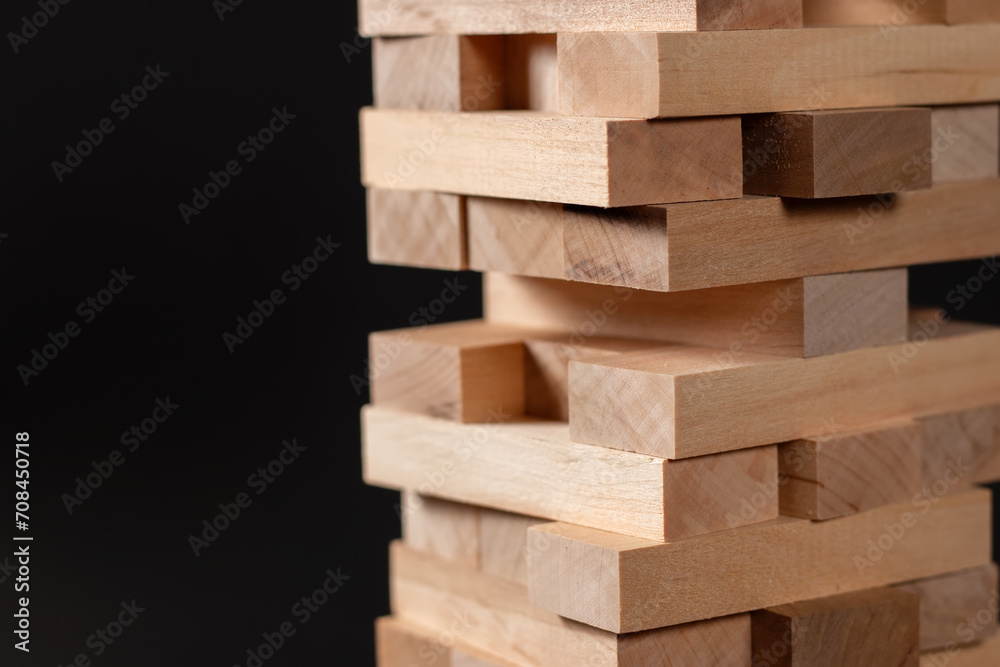 Closeup take one block on The tower from wooden blocks.