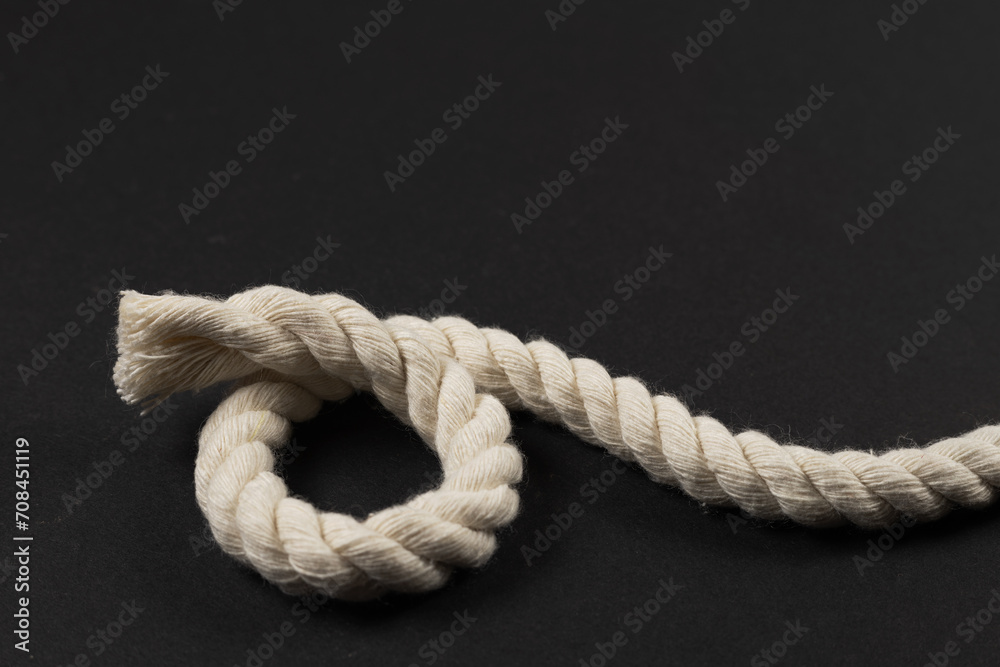 beige rope on dark background close up beige rope on dark background close up