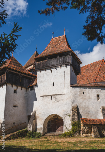 View of Viscri fortified church surrounded by green trees. Romania photo