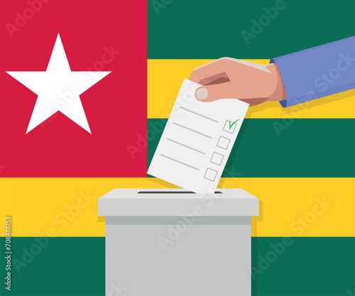 Togo election concept. Hand puts vote bulletin into vote box.