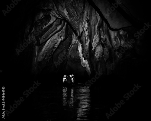 silhouette of a person exploring inside a cave (ID: 708466740)