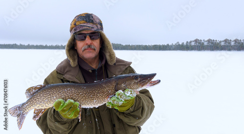 Seasoned Anglers Triumph, Winter Fishing Amidst Snowy Tranquility With a Freshly Caught Pike. Banner, copy space