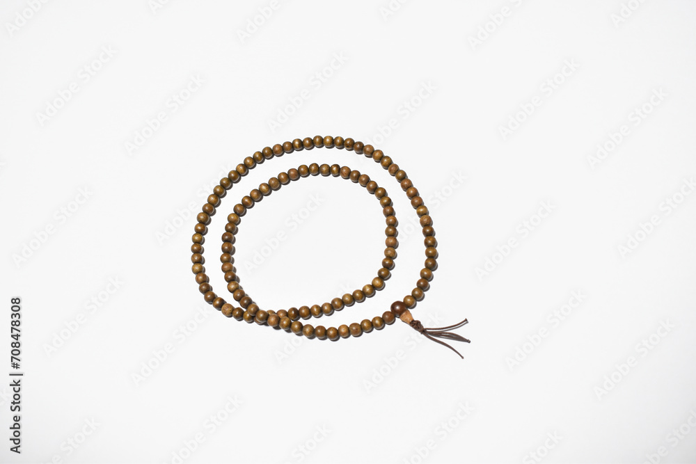 Brown wooden mala beads on a white background ringed two times Brown wooden mala beads on a white background ringed two times