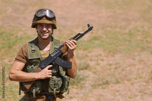 Military, smile and gun with portrait of man in nature for war, conflict and patriotic. Army, surveillance and security with person and rifle training in outdoors for soldier, battlefield and veteran