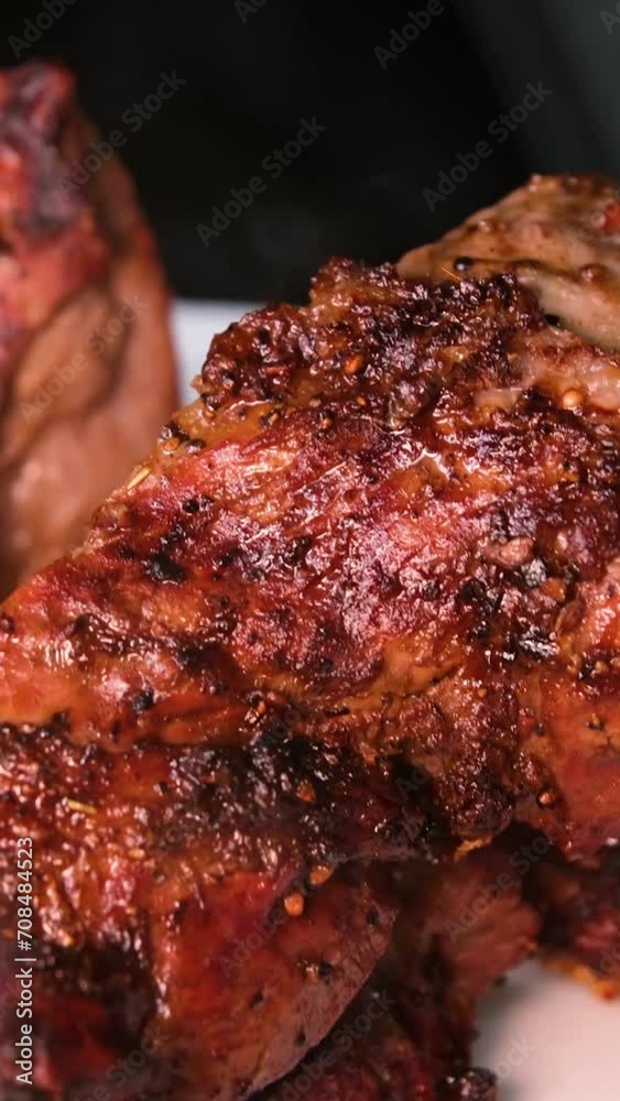 Large ready-made Golden-crusted steak with close-up on charcoal grill. Smoke and heat cooks pork meat on the grill. Dolly sliding video Large ready-made Golden-crusted steak with close-up on charcoal grill. Smoke and heat cooks pork meat on the grill. Dolly sliding video