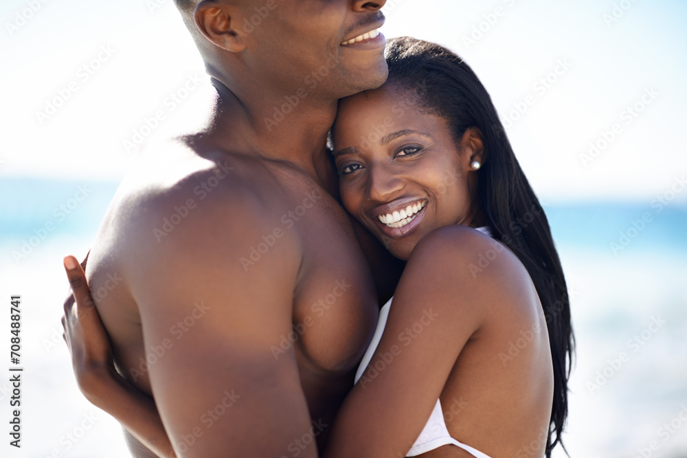 Love, hugging and young black couple at the beach for valentines day vacation, holiday or adventure. Smile, happy and African man and woman on a date by the ocean or sea on weekend trip together.