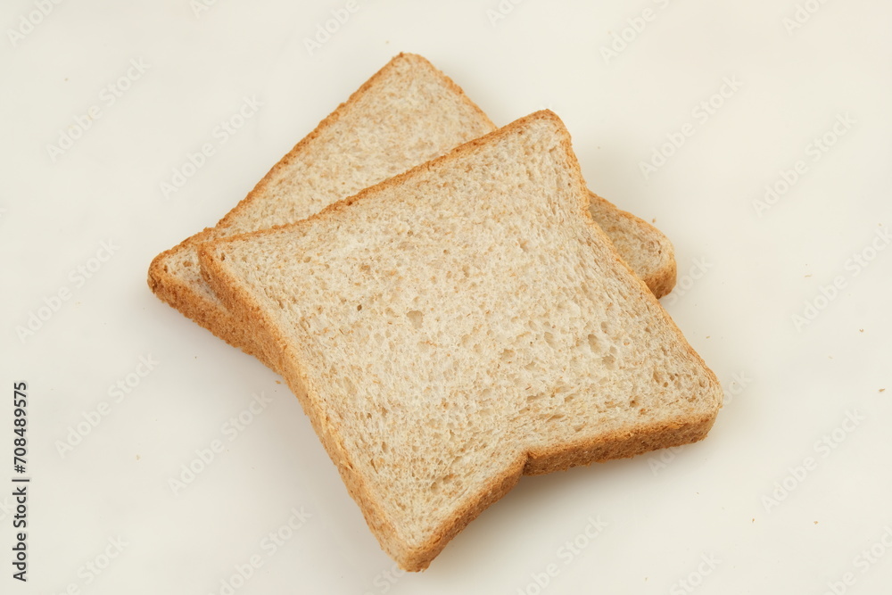 Fototapeta premium Slice of a whole wheat bread isolated on a white background