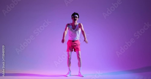 Mustached nerd wearing glasses engages in squats, adding a touch of humor to the routine on a purple backdrop. This quirky scene captures the blend of retro charm and lighthearted workout moments. photo
