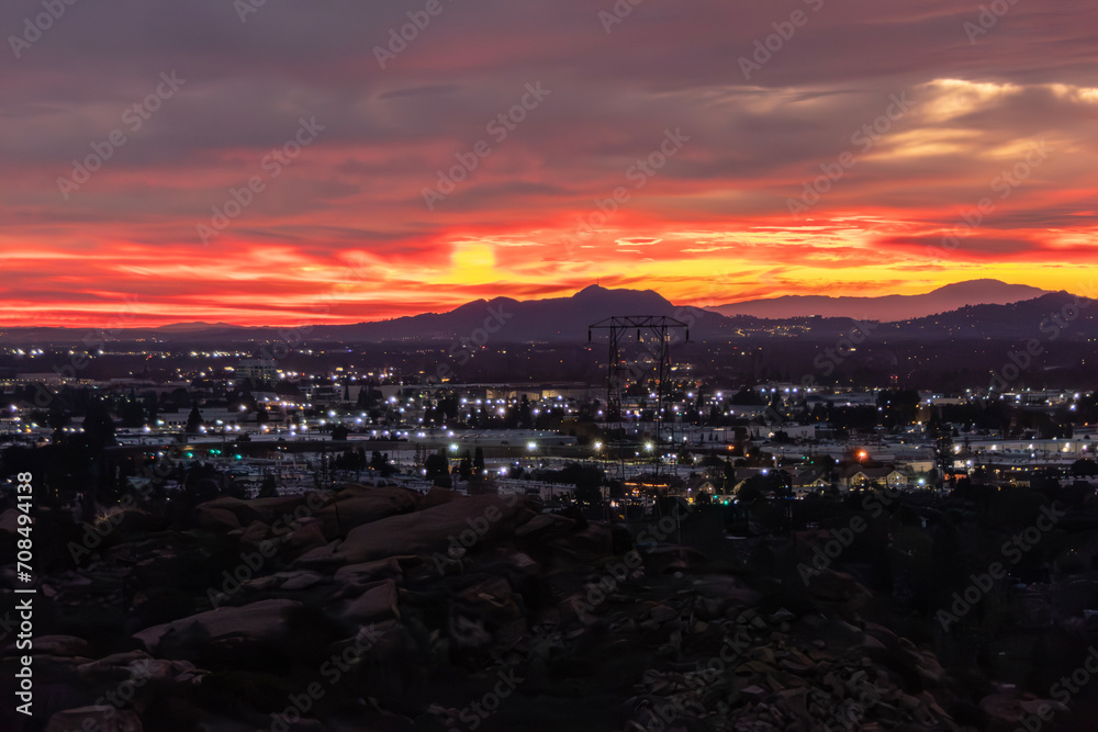 Colorful dawn view of the San Fernando Valley with Griffith Park mountains in the background..  Photograph taken from hilltop in Chatsworth area of Los Angeles California.