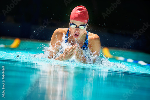 Sports, water splash or woman in swimming pool for competition training, workout or energy. Fitness, breathing or cardio with female swimmer and athlete for exercise, championship and race at gala