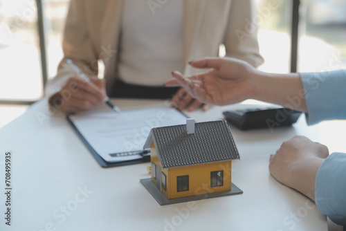 Real estate agent and customer signing contract to buy house, insurance or loan real estate.rent a house,get insurance or loan real estate or property.