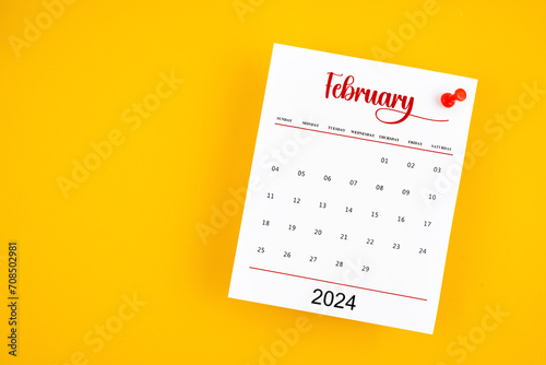 February 2024 calendar page with red push pin on yellow.