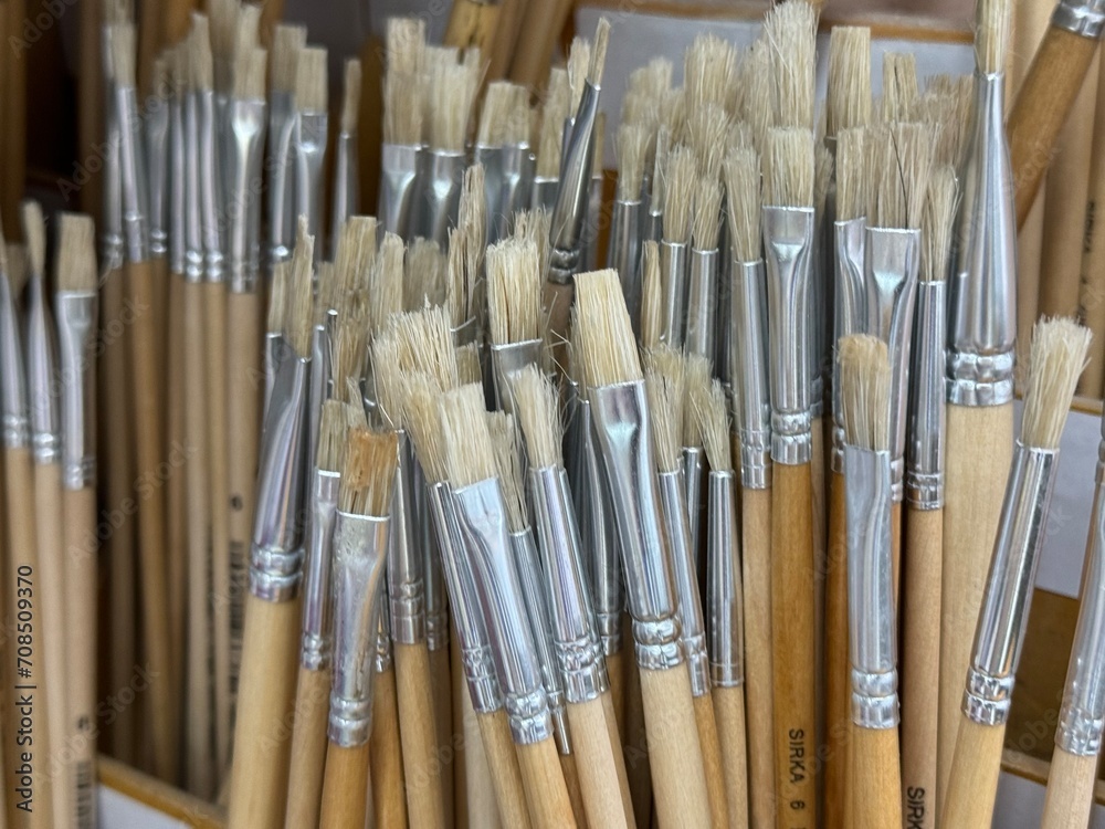 Brushes for painting with watercolor, oil, gouache, acrylic. Flat bristles in the sun's rays. Closeup paint brushes. Shallow depth of field. Background for advertising.
