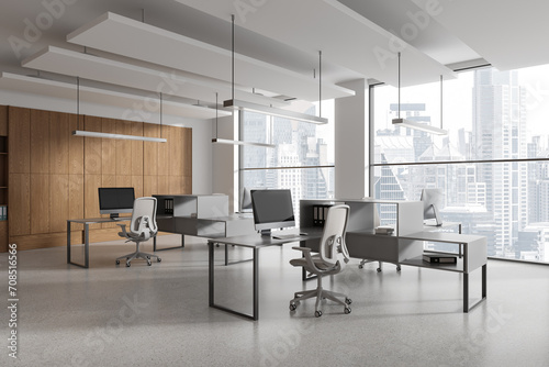 Stylish office interior with desk and shelf, workplace near panoramic window
