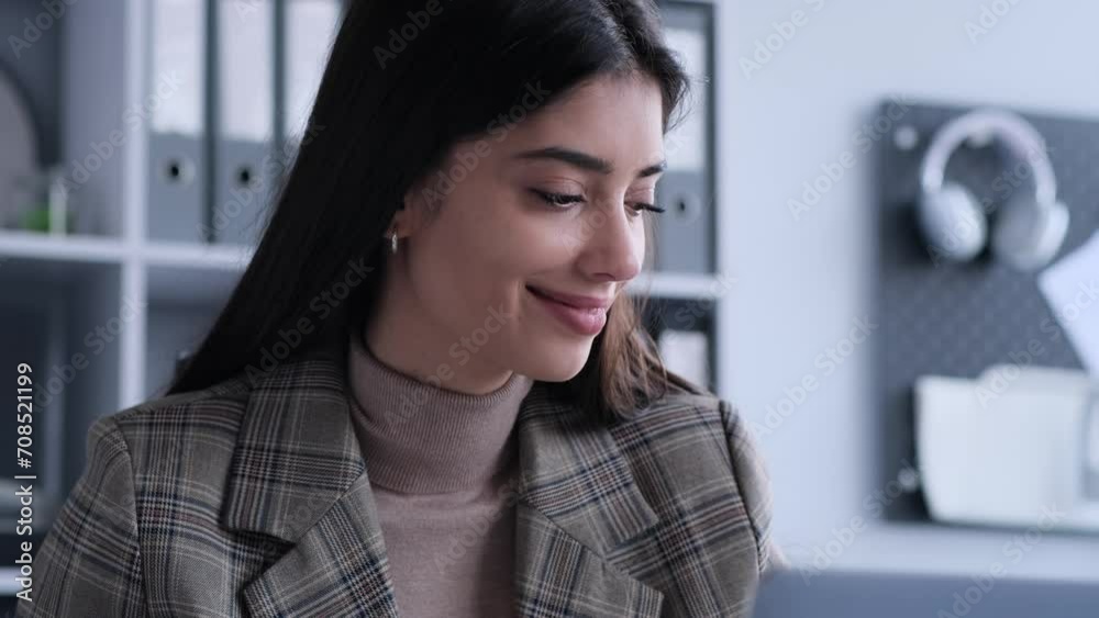 Radiating positivity, a woman works in the office while singing joyfully. This image captures the vibrant and uplifting energy she brings to the workplace, infusing a sense of happiness.
