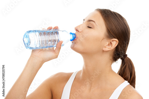 Exercise, woman and drinking water in studio for sports break, energy and detox for healthy recovery on white background. Athlete, hydration and bottle of liquid for nutrition, fitness diet or thirst