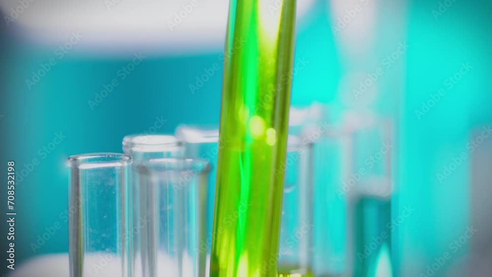 A young laboratory technician in blue gloves holds a test tube in a medical facility. In the laboratory, a specialist holds a flask, using modern research methods to create effective vaccines A young laboratory technician in blue gloves holds a test tube in a medical facility. In the laboratory, a specialist holds a flask, using modern research methods to create effective vaccines