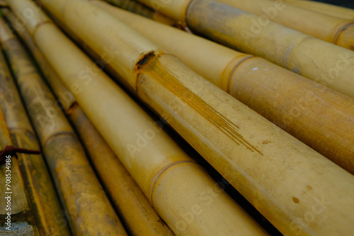 Background Photography. Textured Background. A pile of bunches of old yellow bamboo. Old bamboo is collected on the side of the road for building construction. Bandung  Indonesia
