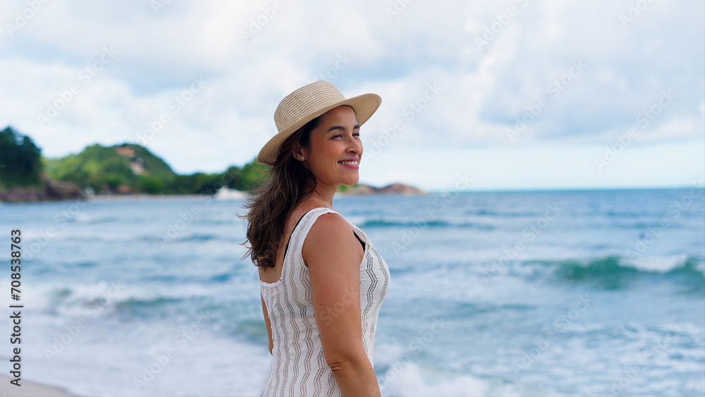 Beautiful girl with straw hat enjoying sunbath at beach. Close up face of young tanned woman with closed eyes enjoying breeze at seaside. Carefree latin woman smiling with ocean in background.
Beautiful girl with straw hat enjoying sunbath at beach. Close up face of young tanned woman with closed eyes enjoying breeze at seaside. Carefree latin woman smiling with ocean in background.