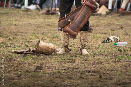 gaucho argentino con sus botas de cuero parado en un campo de domas tradicional photo