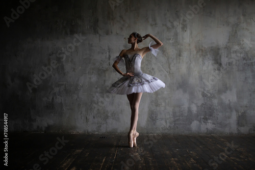 Ballerina performs an element of ballet dance in the studio.