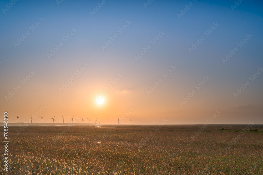 Offshore wind farms are great for enjoying the scenery and watching the sunset. Gaomei Windmill Avenue. Taichung Harbor Wind Power Station. Taiwan.