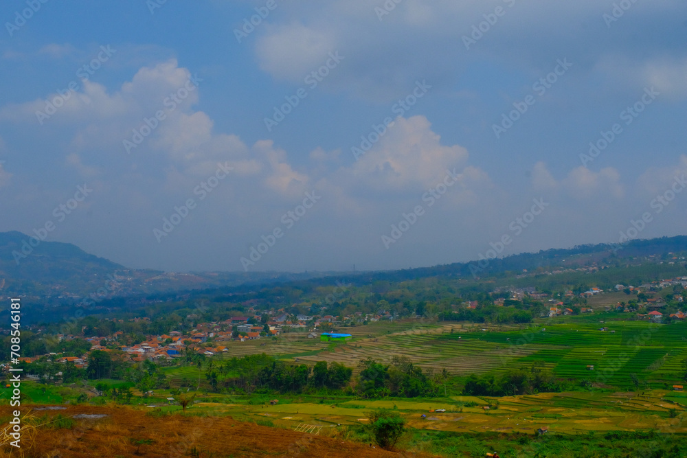 Obraz premium Landscape Photography. Landscape View. Scenic Nature Green and fertile hillsides. Beautiful hill landscape with blue sky background. Bandung, Indonesia