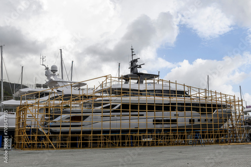 Luxury super yacht ashore on ship repairing yard. Yard period. Repairing. Motor yacht.