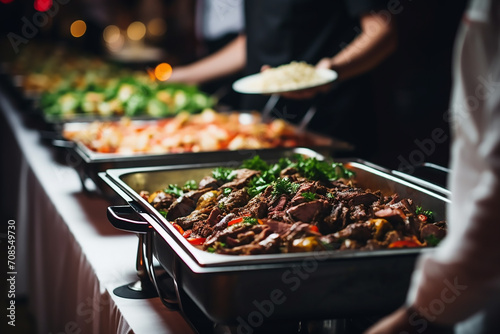 Group of people on catering buffet food indoor in restaurant with grilled meat. Buffet service for any festive event, party or wedding reception