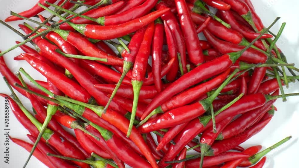 Explore the mesmerizing world of red chili peppers in exquisite detail. Macro footage reveals their fiery hues, glistening textures, and hidden beauty. Spicy and heat concept. Food stock footage.
Explore the mesmerizing world of red chili peppers in exquisite detail. Macro footage reveals their fiery hues, glistening textures, and hidden beauty. Spicy and heat concept. Food stock footage.
