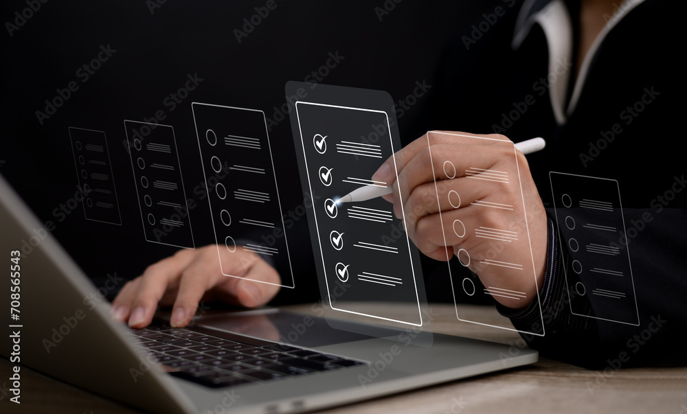 A businessman uses a stylus pen on his laptop to complete performance checklists for online assessments, surveys, and exams, providing a digital and efficient approach to evaluation A businessman uses a stylus pen on his laptop to complete performance checklists for online assessments, surveys, and exams, providing a digital and efficient approach to evaluation