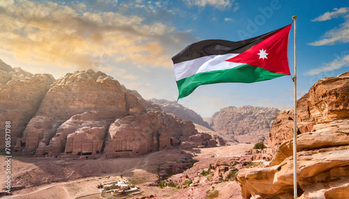 Jordan flag waving on the wind against Petra and Jordan city