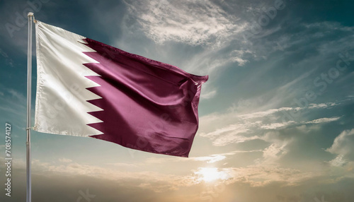 Qatar national flag waving in beautiful sky. photo