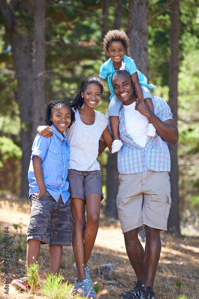 Happy, portrait and black family in forest bonding, fun or walking in nature together. Love, support and children with parents in a park for hiking adventure, journey or travel, explore or vacation