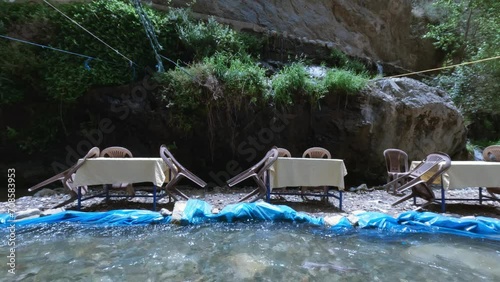 Row of Tables and chairs of a restaurant along the rivers of the Ourika Falls in Sti Fadma, Morocco photo