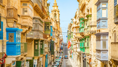 Narrow street with colorful balconies in Valletta old town, Malta photo