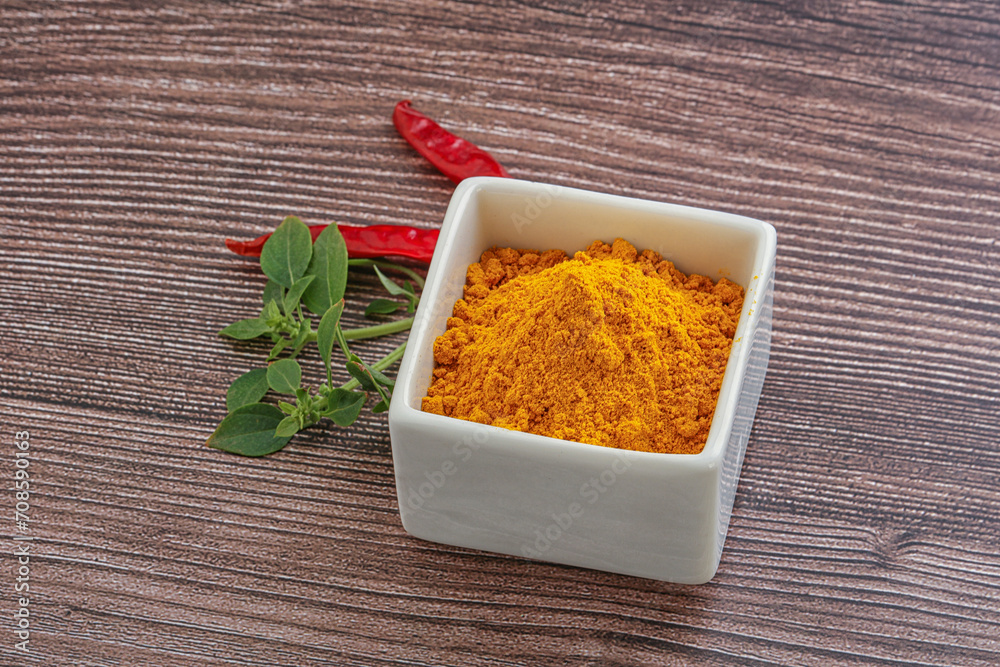 Yellow vibrant curcuma powder in the bowl Yellow vibrant curcuma powder in the bowl