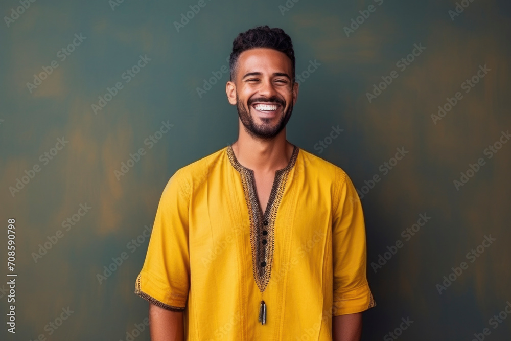 happy Moroccan man with typical moroccan tunic standing against wall happy Moroccan man with typical moroccan tunic standing against wall