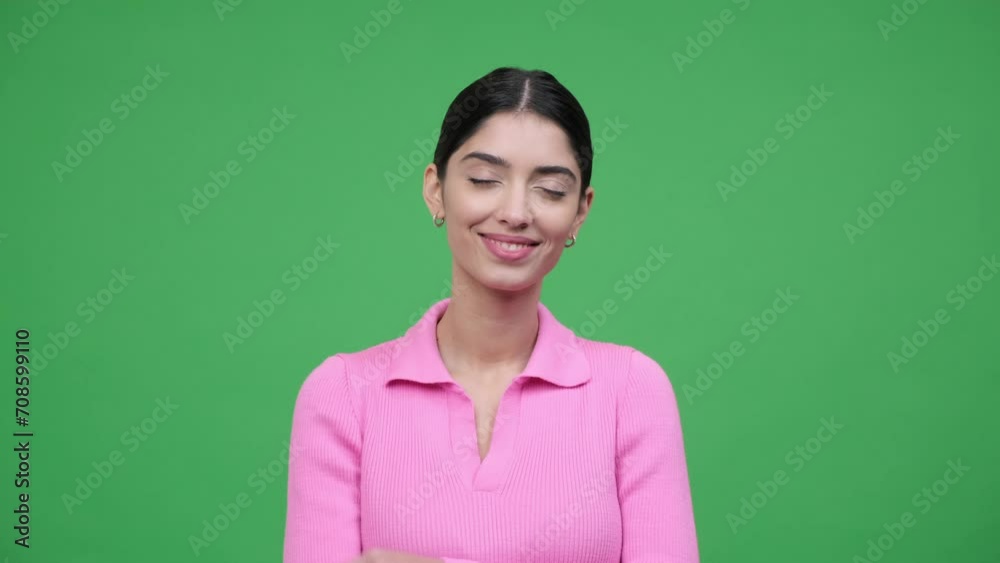 Positive Caucasian woman is captured in a portrait with crossed arms, radiating confidence and optimism. The green background creating scene filled with positivity and self assuredness. Positive Caucasian woman is captured in a portrait with crossed arms, radiating confidence and optimism. The green background creating scene filled with positivity and self assuredness.