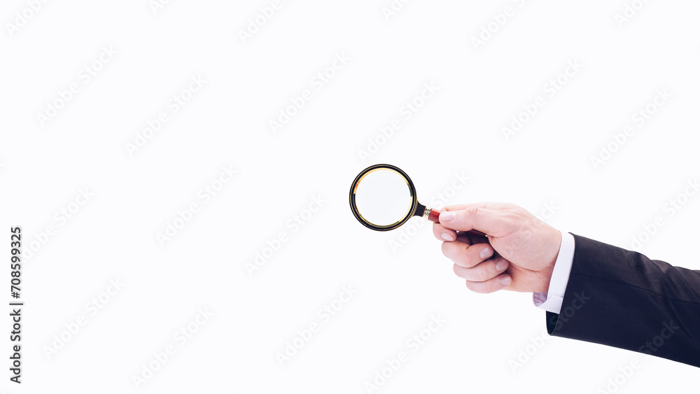 A businessman's hand holds a magnifying glass. On a white background. Research detective. A businessman's hand holds a magnifying glass. On a white background. Research detective.