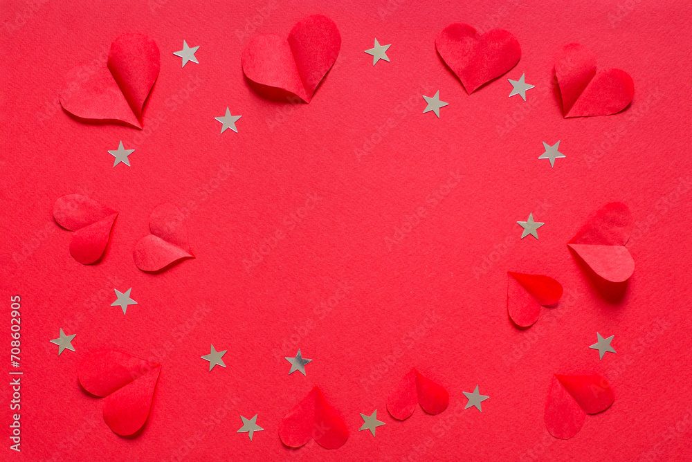 Valentine's, birthday or wedding day festive pattern, many red paper hearts and confetti stars for greeting card on red background top view and flat lay.	
