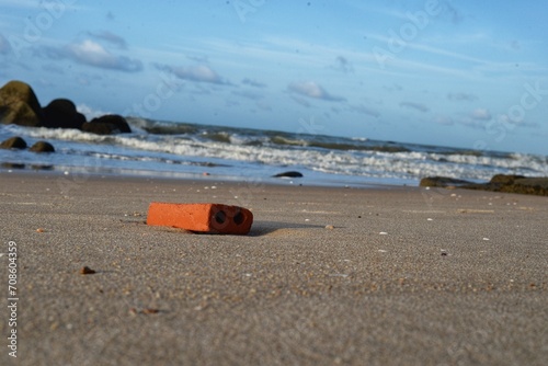a brick on the beach in the morning