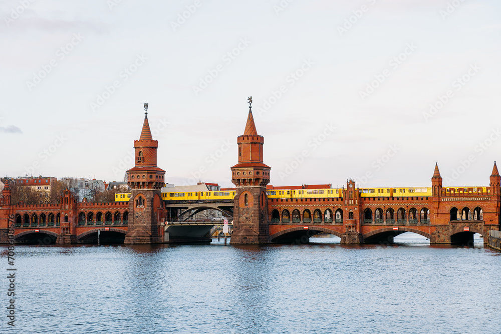 yellow subway train crossing oberbaum Bridge in Berlin, Germany
