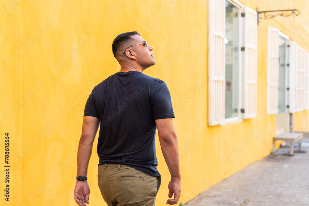 Contemplative Man by Yellow Wall
