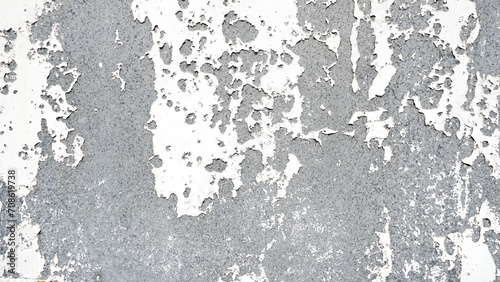 White paint peeling off concrete wall, old white painted background.