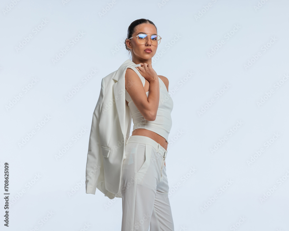 cool elegant businesswoman with glasses with jacket over shoulder cool elegant businesswoman with glasses with jacket over shoulder