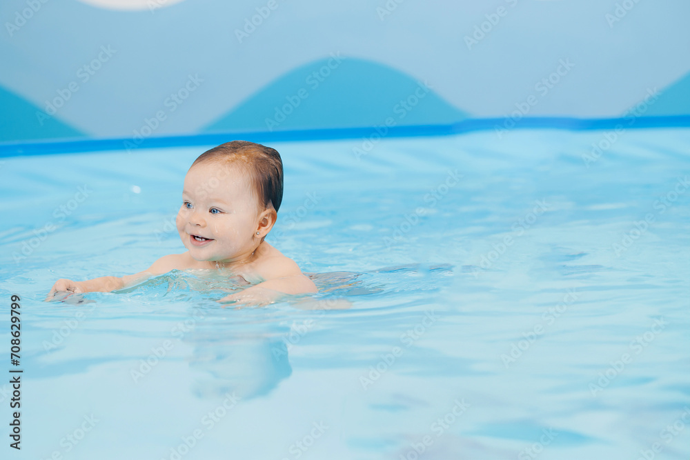 Portrait happy baby girl in swimming pool, teaching small swimmer. Concept healthcare sport for infant Portrait happy baby girl in swimming pool, teaching small swimmer. Concept healthcare sport for infant