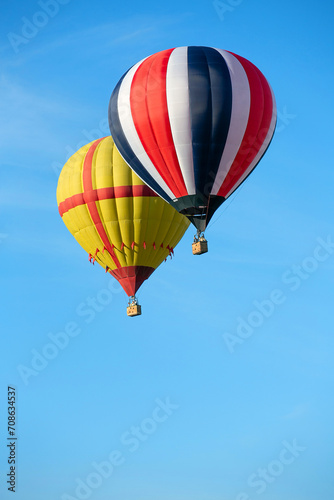 Colorful hot air balloon against the blue sky. Balloon flight.
