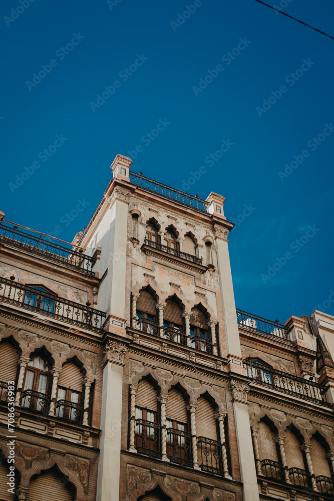 Seville's Architectural Tapestry: Vintage and Moroccan Fusion Against Azure Sky